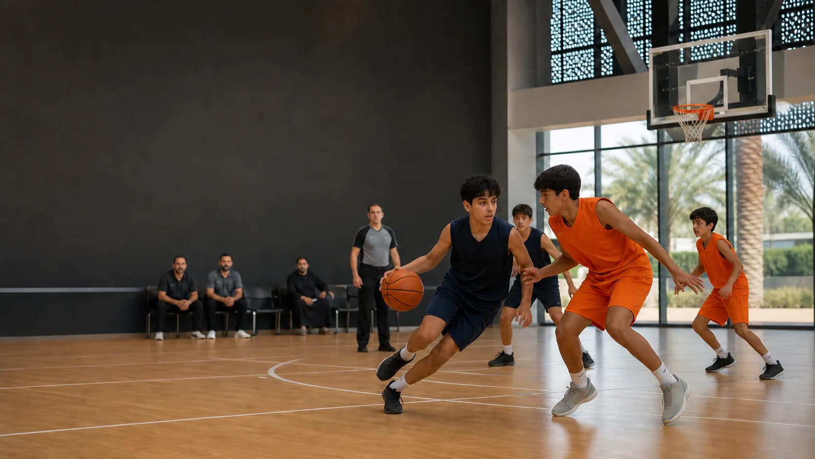 Youth basketball players competing in an organised game inside a modern UAE sports hall